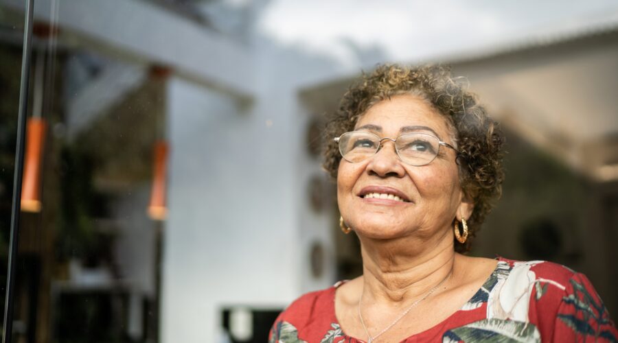 Happy senior woman contemplating at home