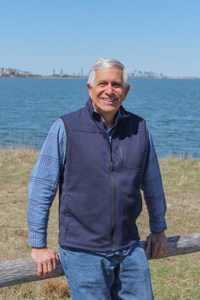 author posed in front of ocean