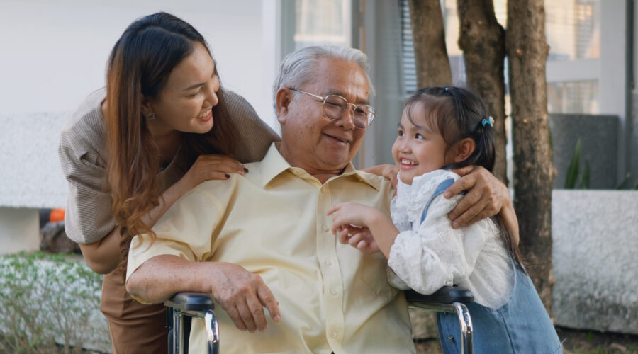 Asian man in wheelchair with daughter and granddaughter